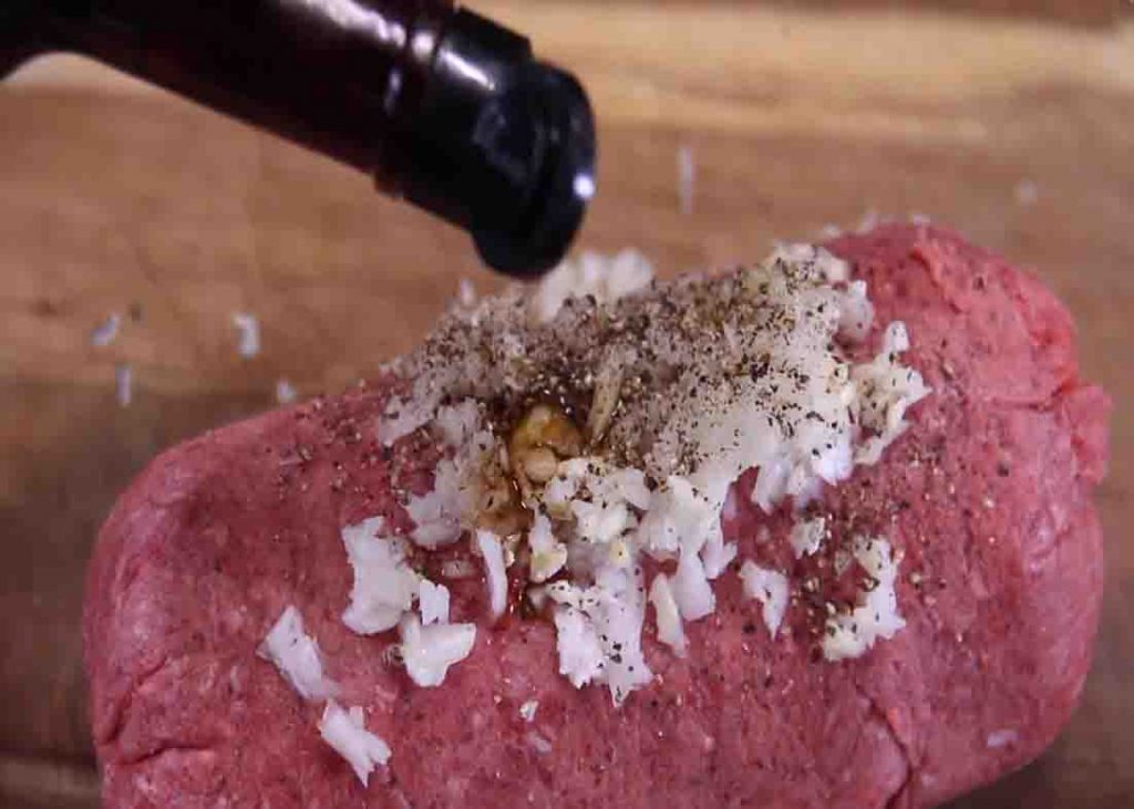 Seasoning the ground beef for the salisbury steak recipe