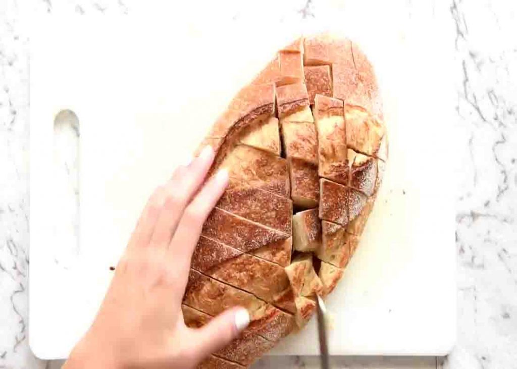 Slicing the top of the bread in a crisscross form