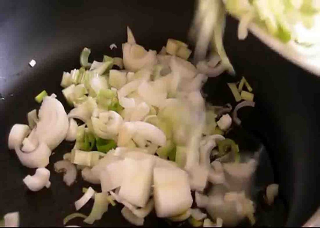 Sauteing the green onions for the baked potatoes recipe
