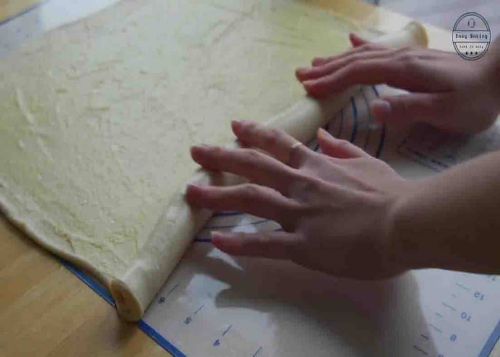 Rolling the custard bread roll dough into a log