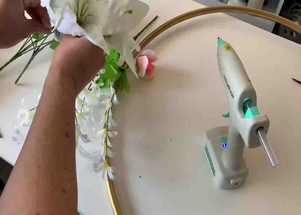 Attaching the faux flowers to the DIY cake stand