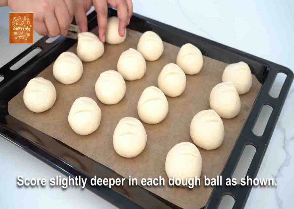 Placing the milk bread dough ball to the baking tray
