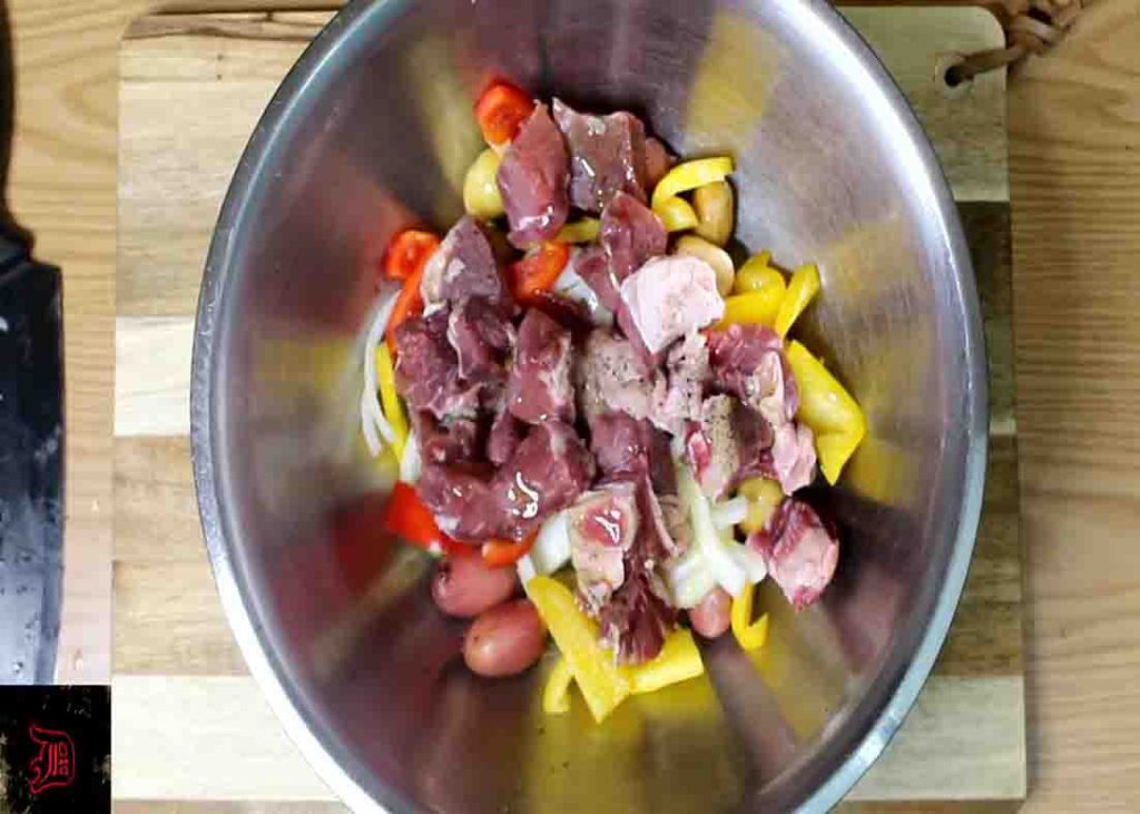 Seasoning the chopped steak and potatoes