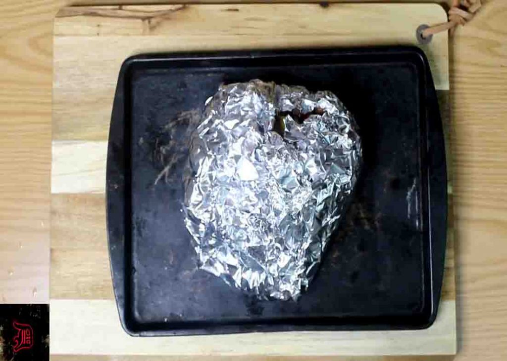 Putting the steak mixture to the prepared foil pack before baking 