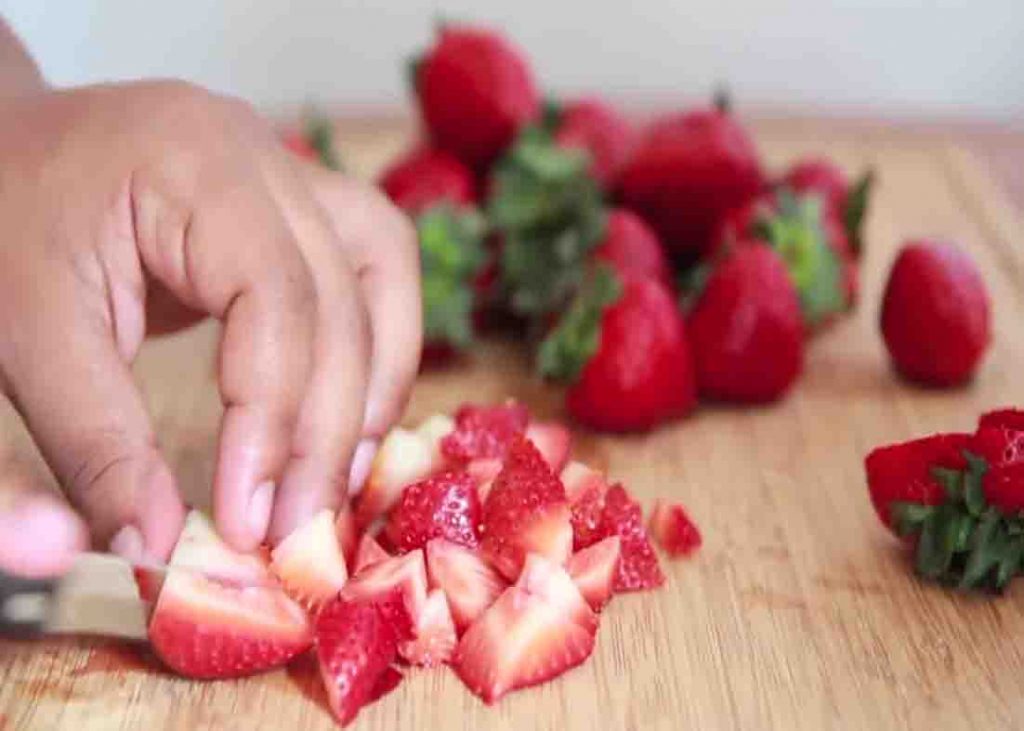 Dicing the fresh strawberries for the cobbler