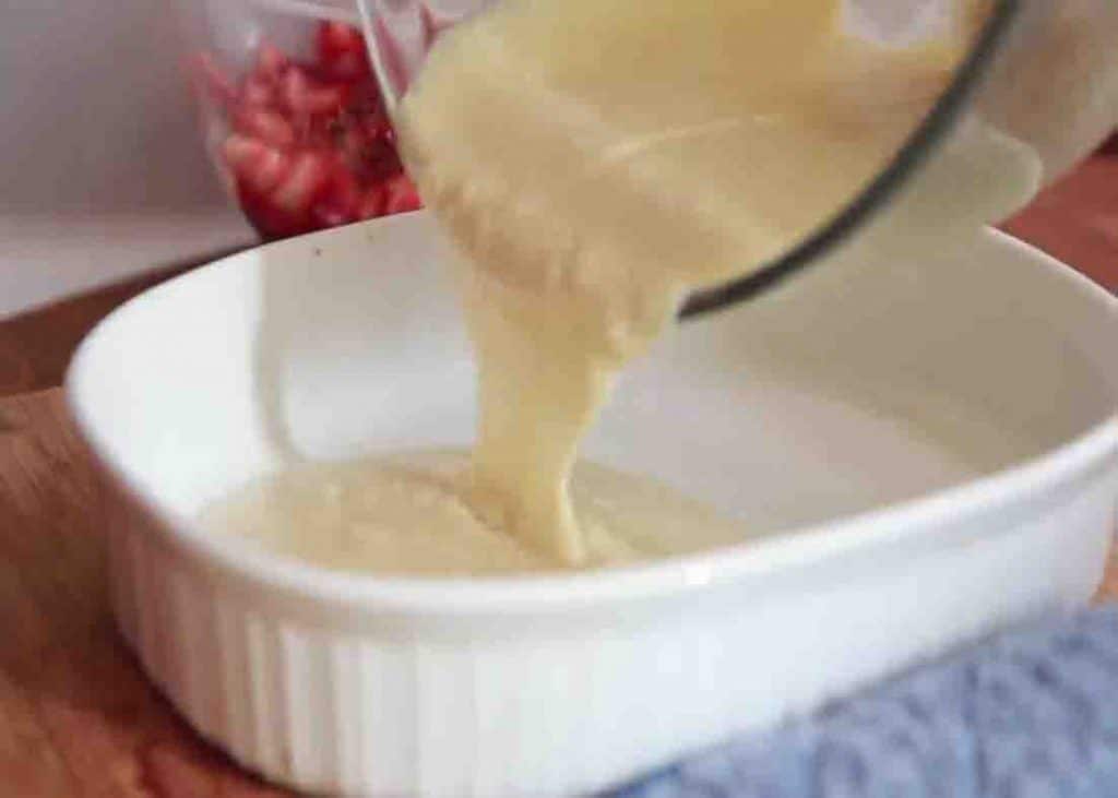 Pouring the cobbler batter to the casserole dish