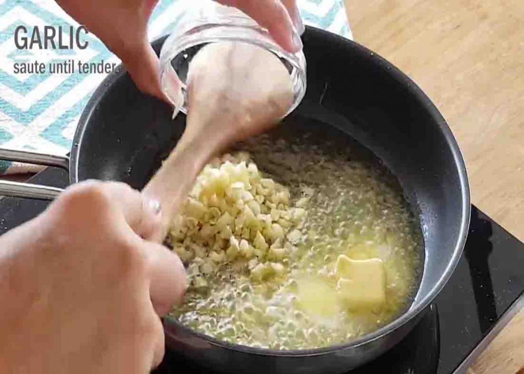 Sauteing the minced garlic for garlic mushroom and baby potatoes recipe