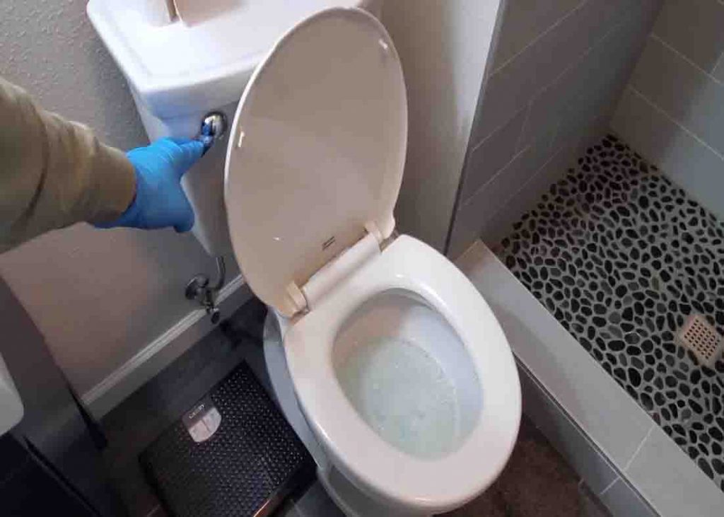 Flushing the clogged toilet