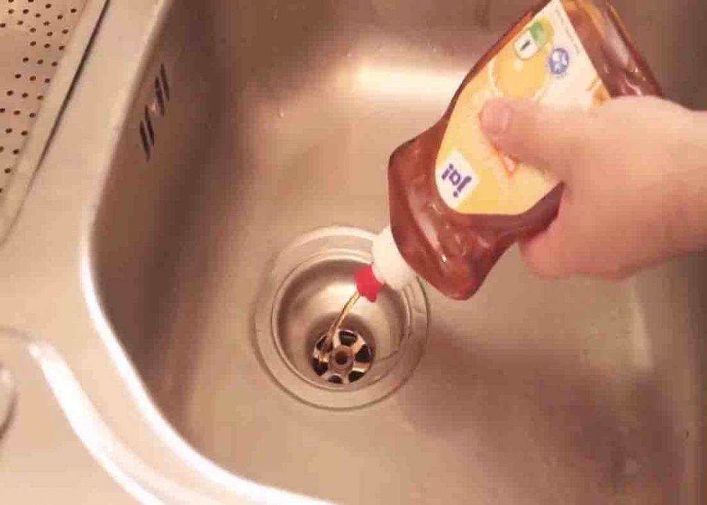Pour a large amount of dishwashing soap to clogged drain