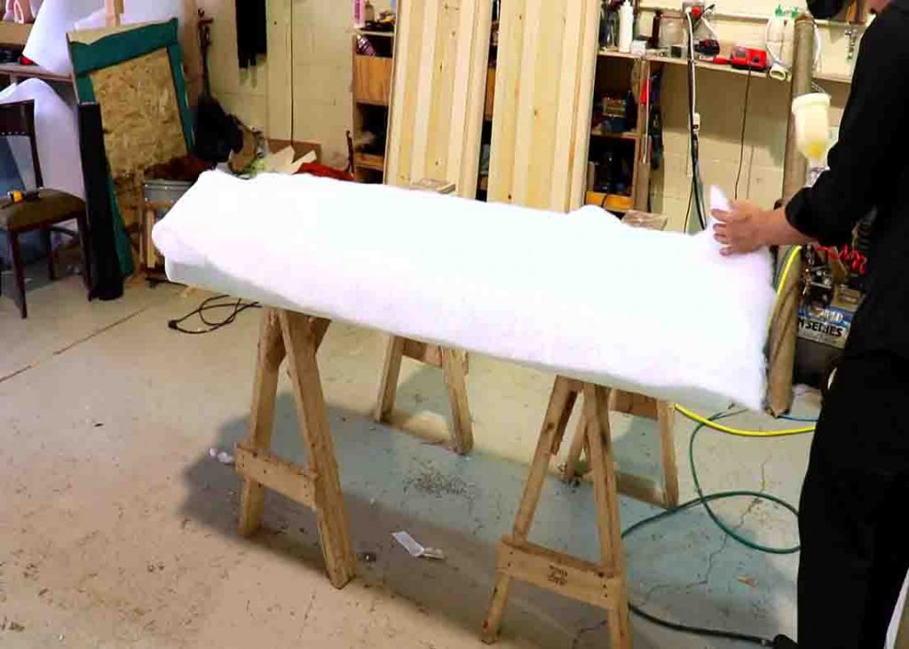Spraying foam glue to the foam and fiber
