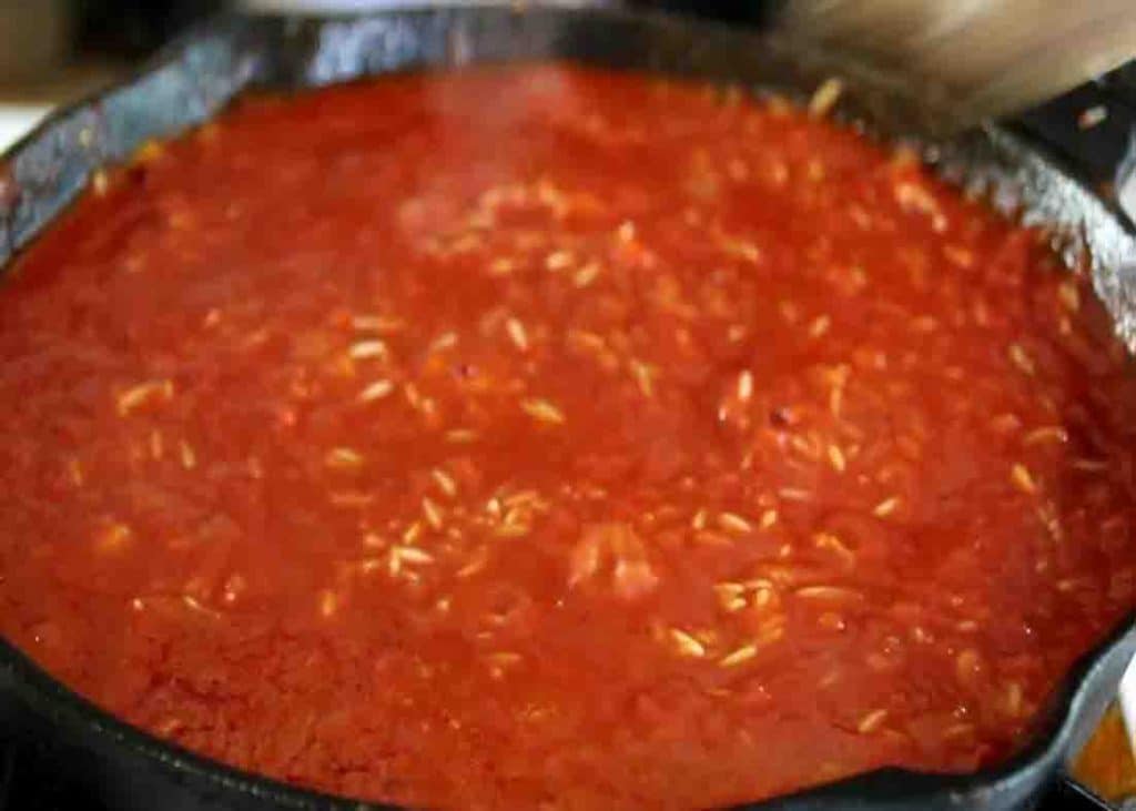 Cooking the tomato chicken and rice