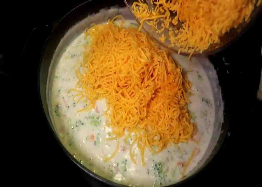 Adding the cheese to the Panera broccoli cheddat soup