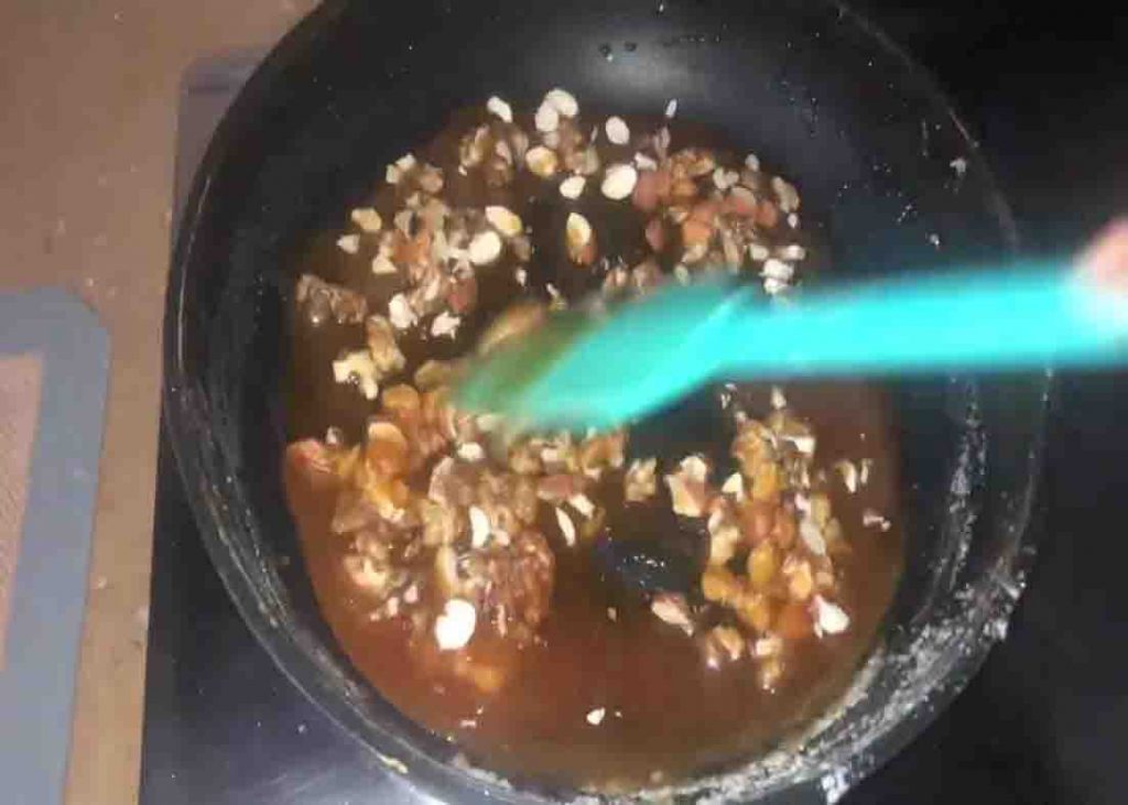 Caramelizing the sugar with nuts for the pineapple crush delight recipe