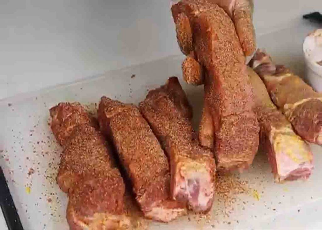 Coating the country-style ribs with homemade dry rub