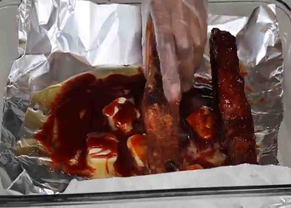 Coating the country-style ribs with honey bbq sauce