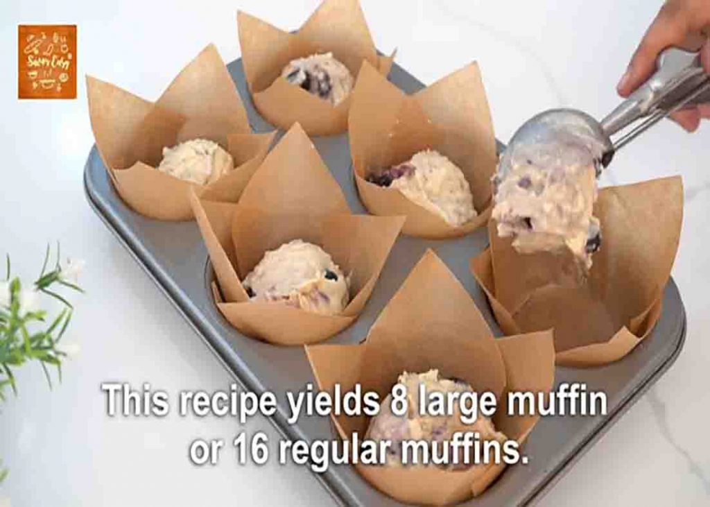 Pouring the blueberry muffin batter on each muffin cup
