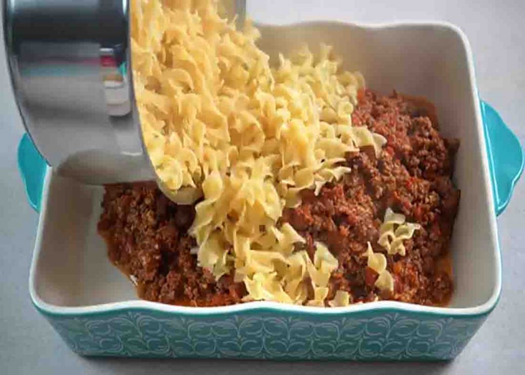 Assembling the cheesy ground beef casserole