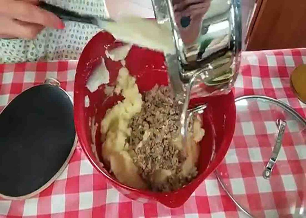 Mixing the mashed potato and the Italian sausage mixture
