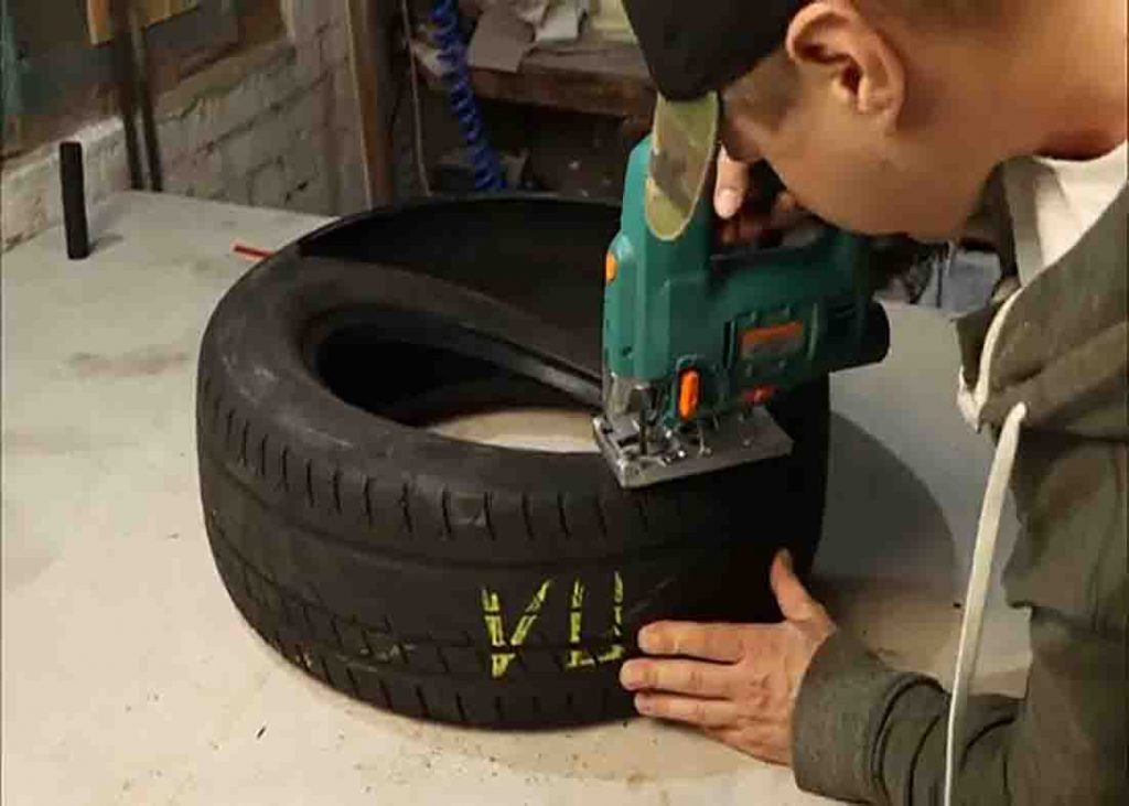 Cutting the top portion of the old tire for the DIY pet bed