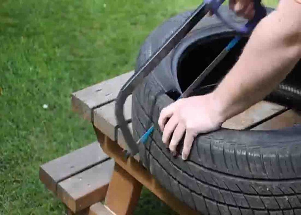 Cutting the tire in half for the DIY seesaw