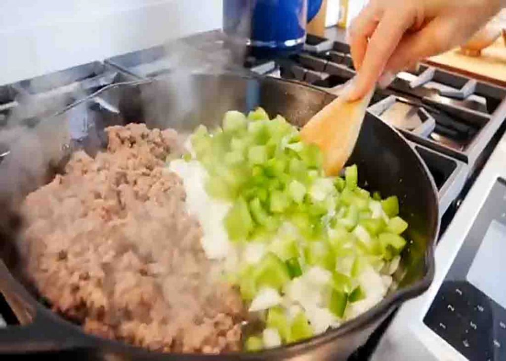 Mixing the veggies and the meat for the ground beef skillet recipe