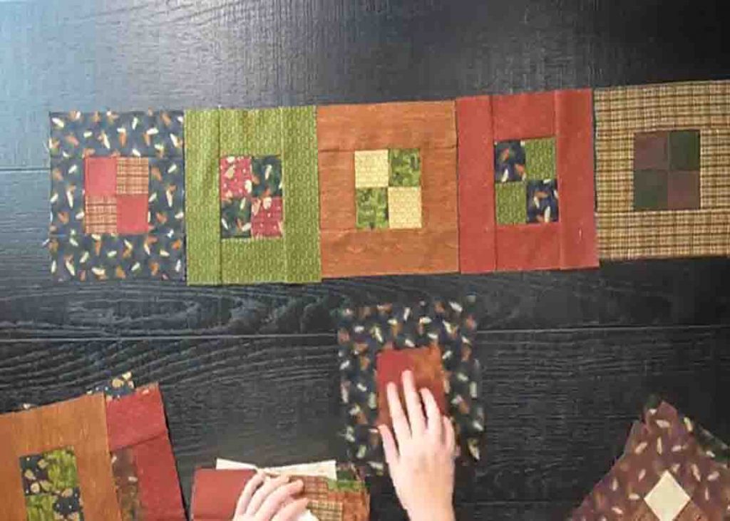 Layering the four-patch blocks to make the quilt top