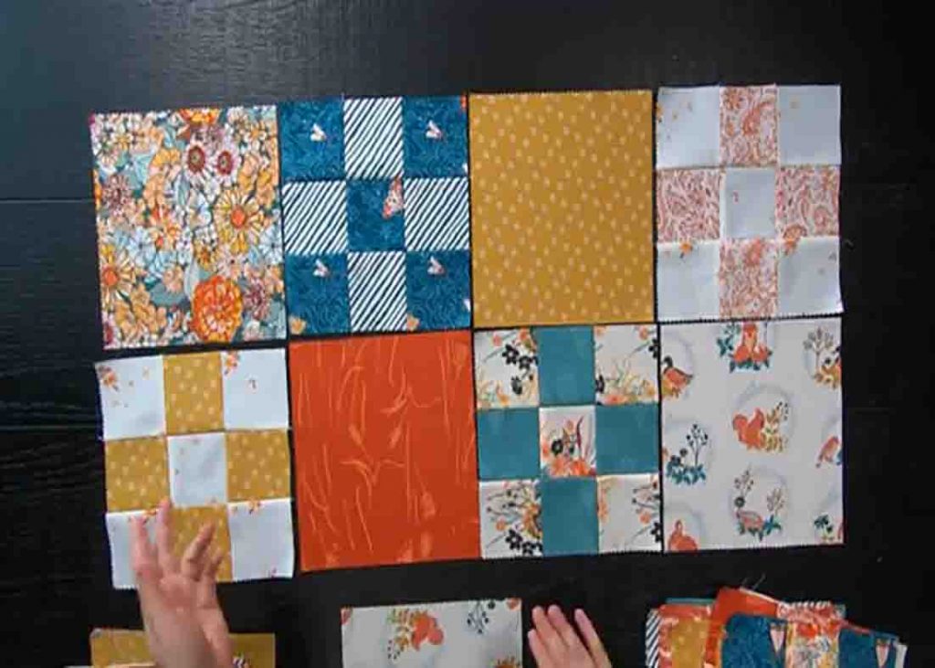 Layering the layer cake garden games quilt top