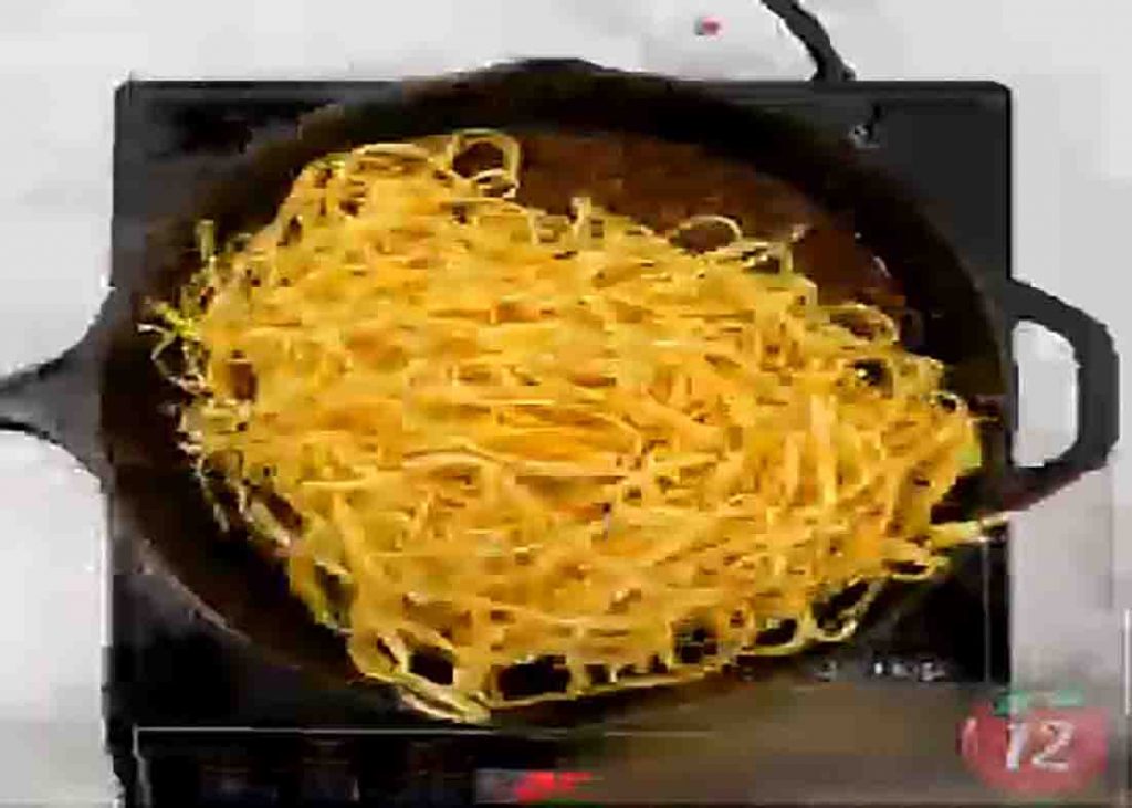 Tossing the noodles with the ground beef mixture