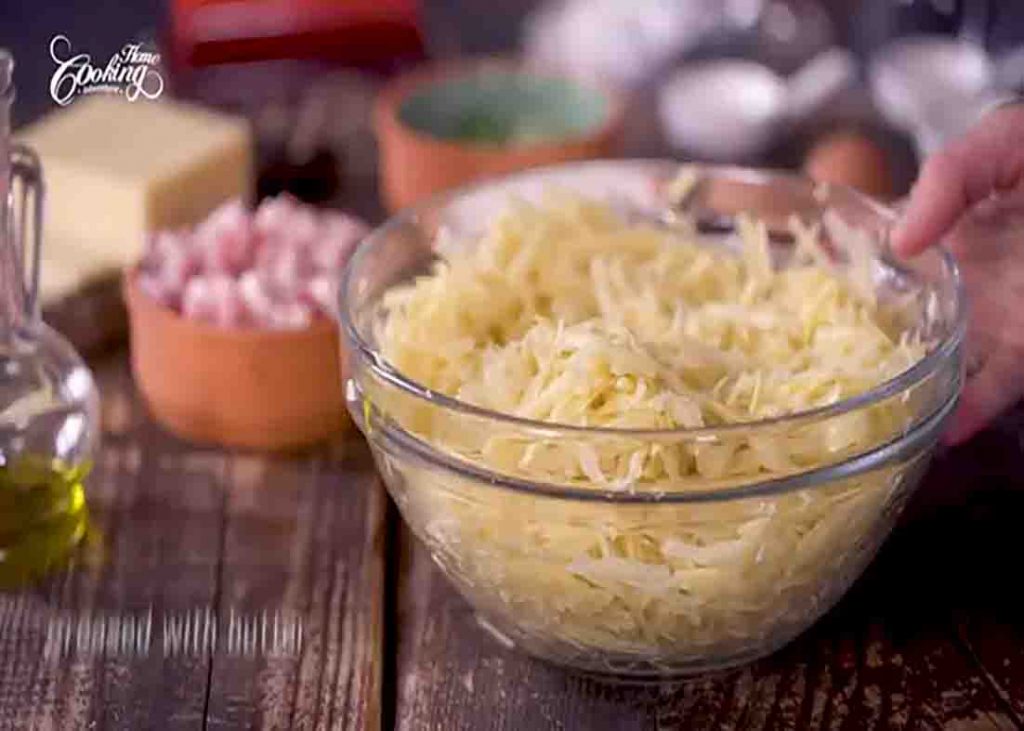 Seasoning the shredded potato for the potato crust quiche recipe