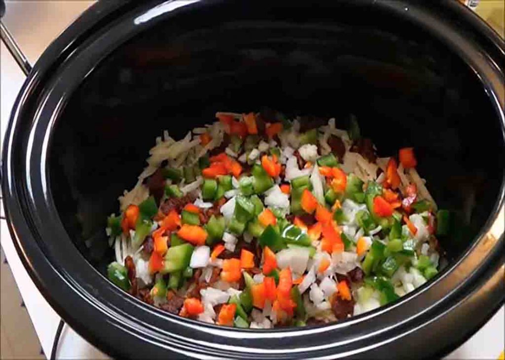 Adding the hashbrown casserole ingredients to the slow cooker