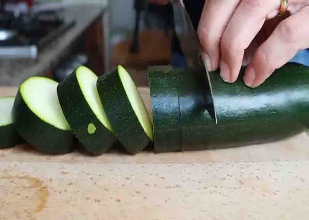 Slicing the zucchini into thick cut