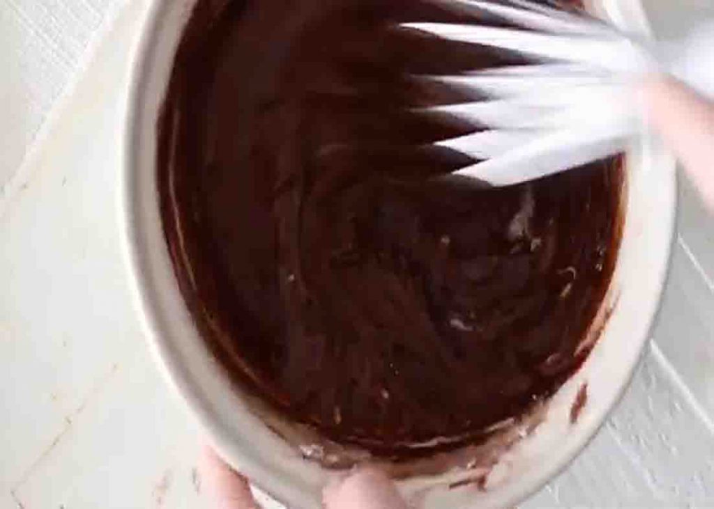 Whisking the chocolate frosting