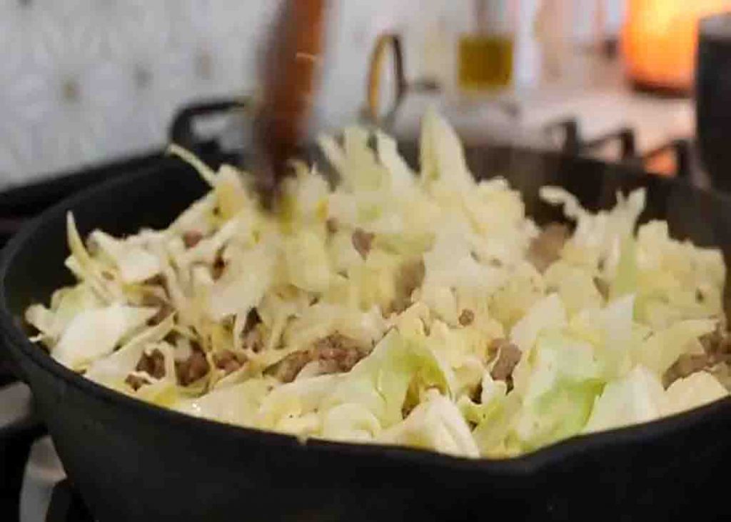 Cooking the ground beef and cabbage