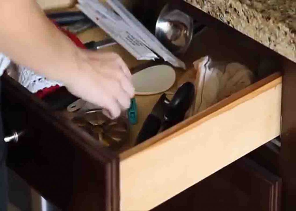 Removing all the stuff from the kitchen drawers and cabinets