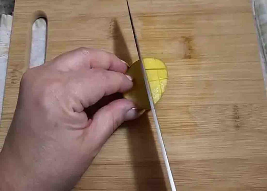 Slicing the top of the potatoes for the crispy parmesan potatoes recipe