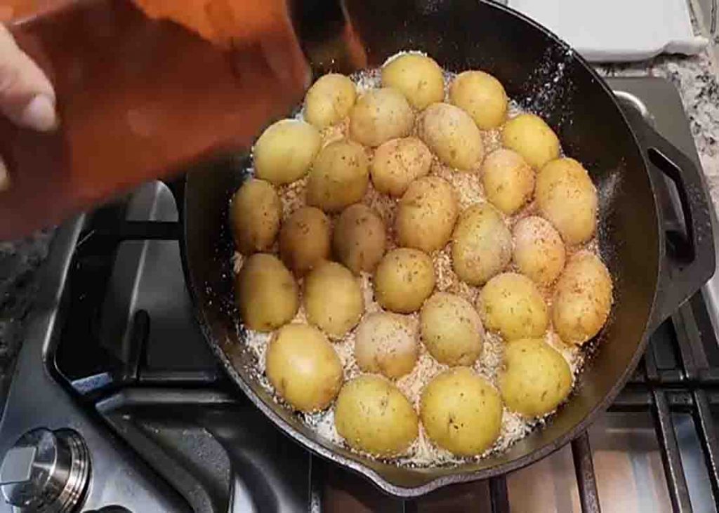 Seasoning the parmesan potatoes