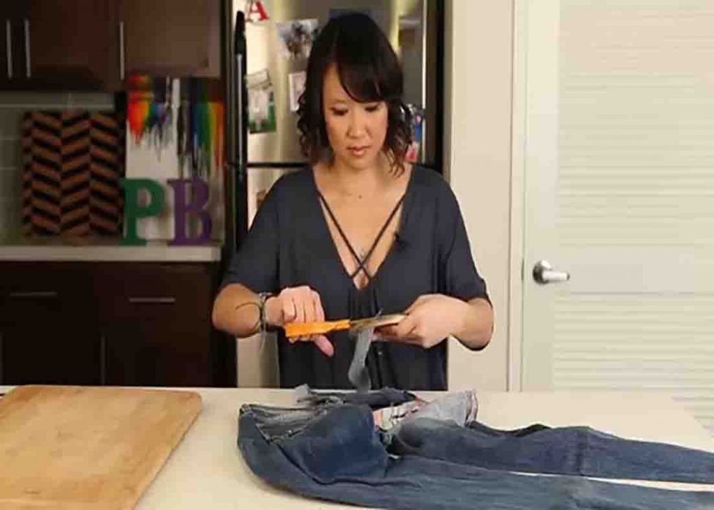 Cutting the excess denim fabric from the DIY organizer