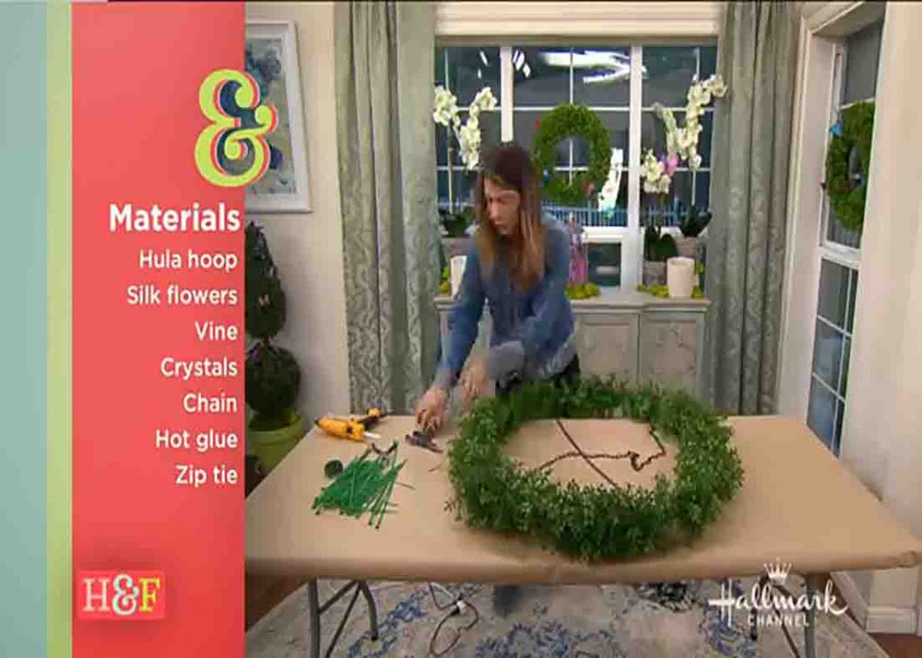Wrapping the hula hoop with garland to make the floral chandelier