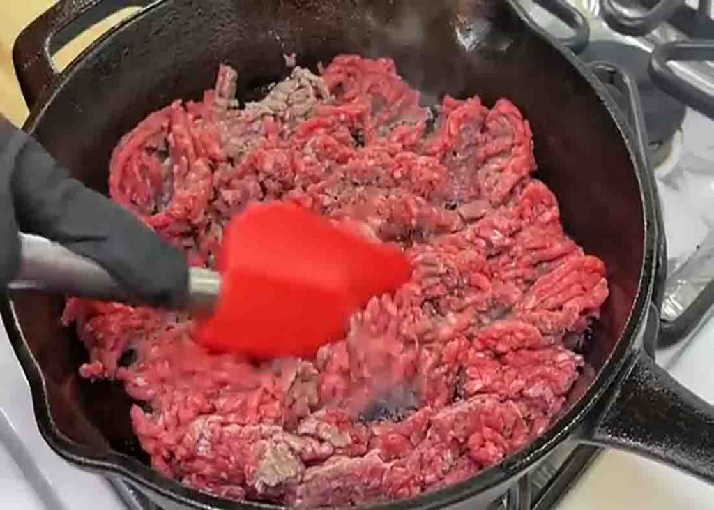 Breaking the ground beef for the casserole recipe