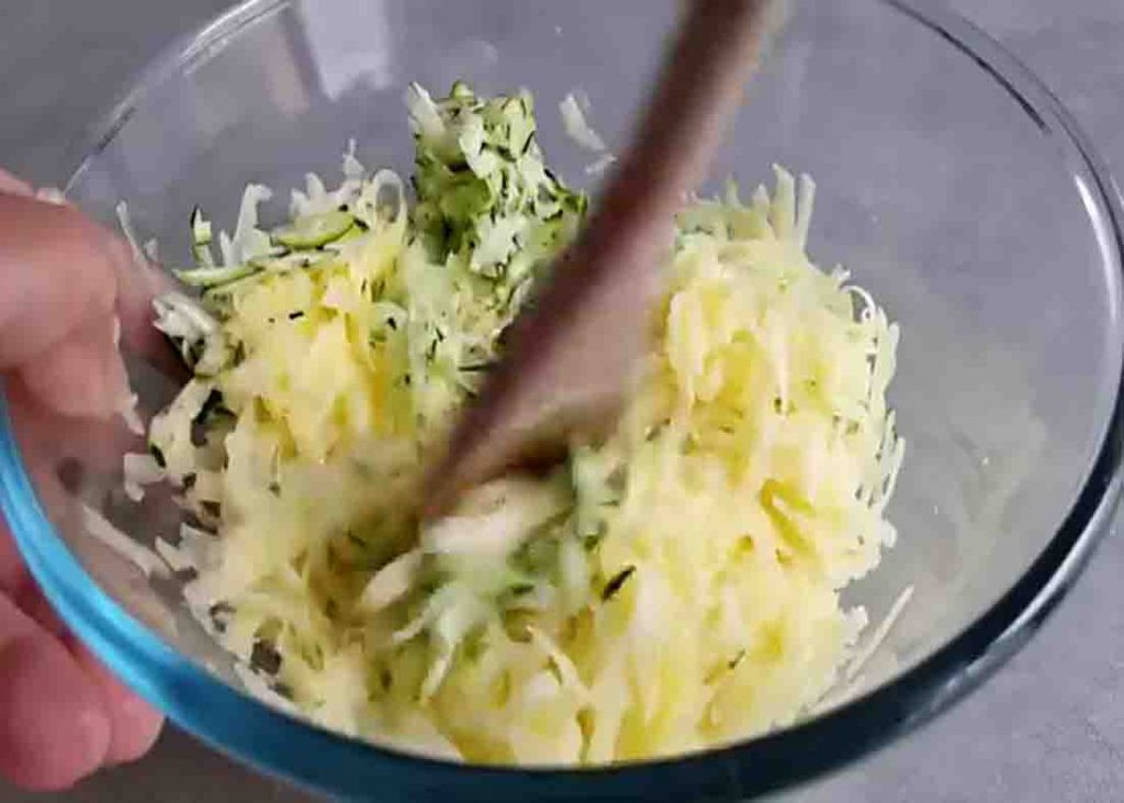 Mixing the potatoes and zucchini for the zucchini pancakes