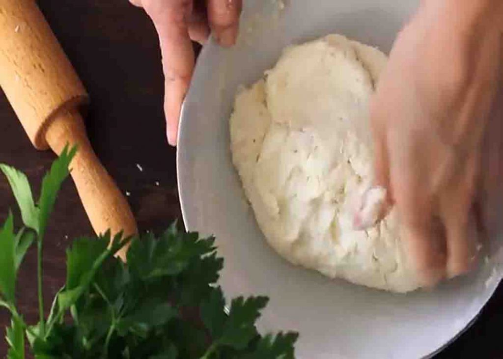 Kneading the dough for the garlic cheese bombs