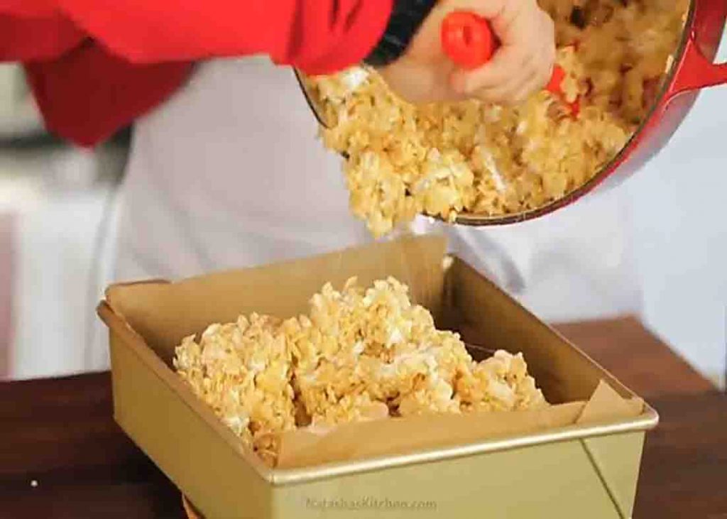 Transferring the rice krispie treats to the baking pan