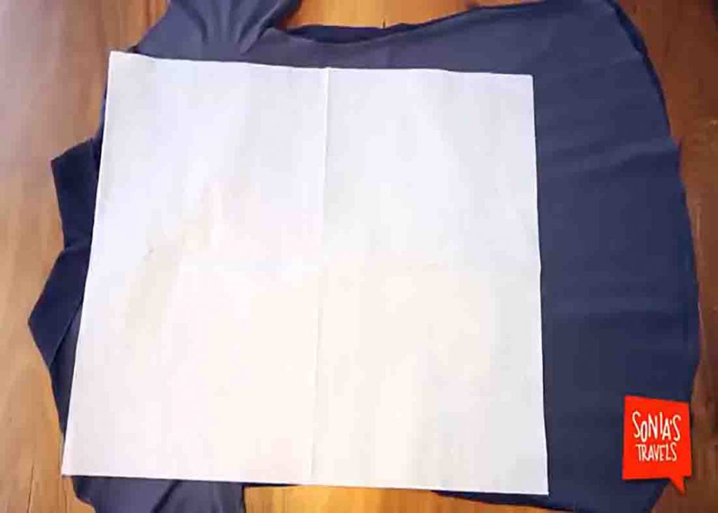 Putting tissue over the clothes' creases to avoid wrinkling