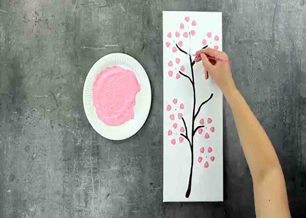 Painting the branches of the cherry blossom tree