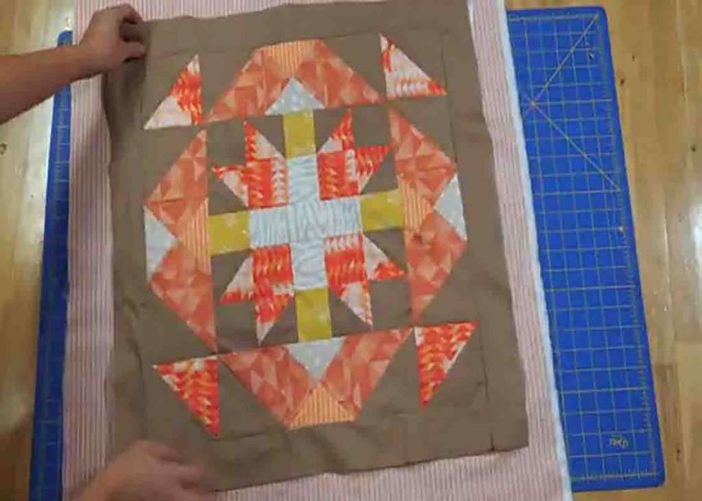 Putting the backing, batting, and the quilt block together