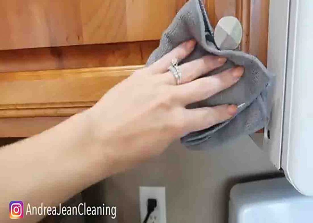 Wiping the cabinets with microfiber towel