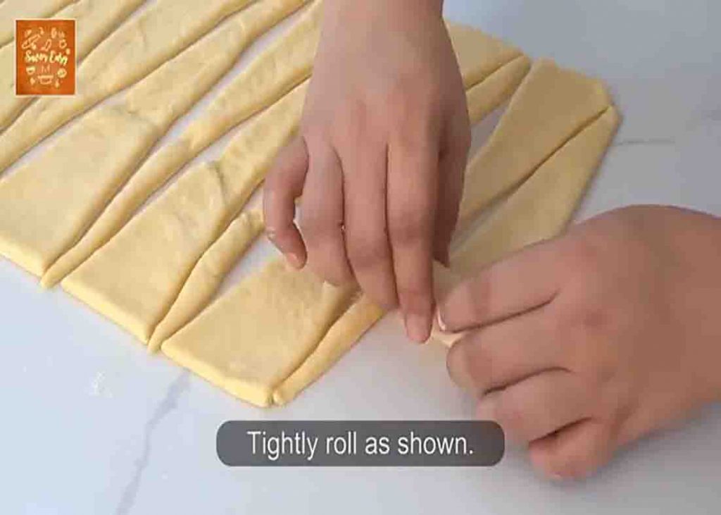 Rolling the dough to make the custard bread