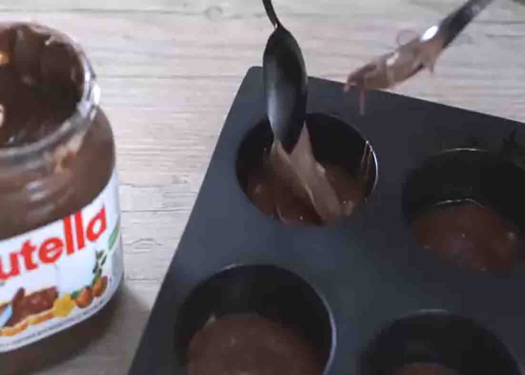 Transferring the nutella muffin batter to the muffin tray