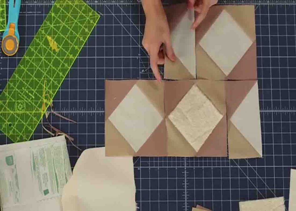 Laying out the blocks to make the stacking blocks quilt top
