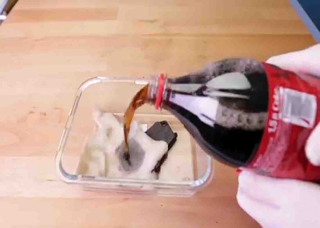 Soaking the rusted object in Coca-Cola